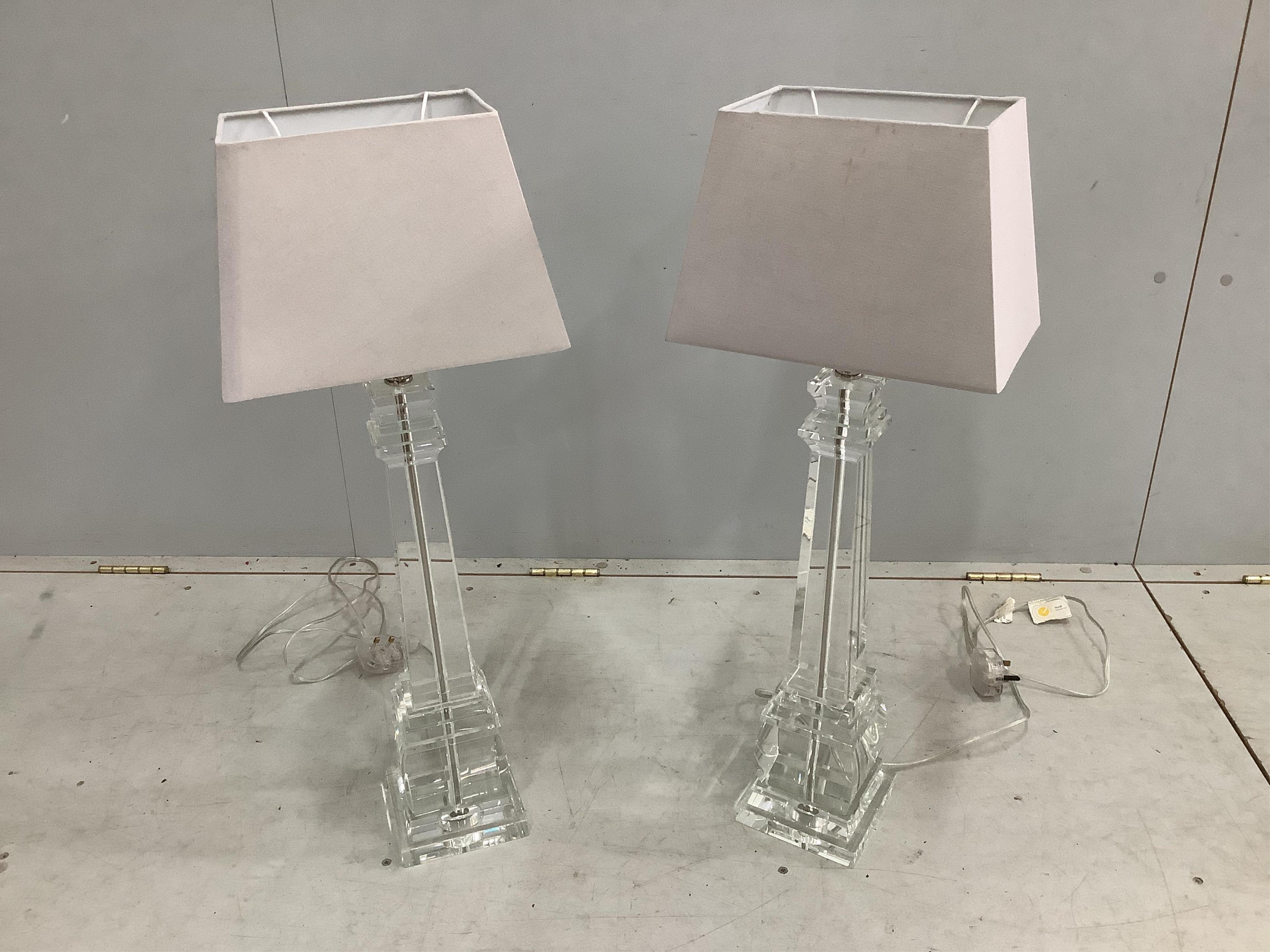 A pair of glass pillar shaped table lamps, 54cm high not including fitment or shade.